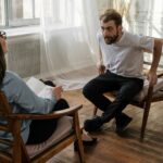 Žena meditujúca v pokoji na pozadí prirodzeného svetla.